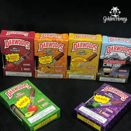 Variety of DabWoods cartridges showcasing flavors like apple, banana, and grape with 85% potency, styled in colorful packaging.